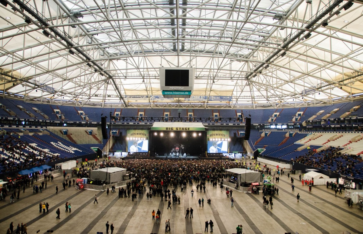 A large esports tournament arena with bright lights and stage